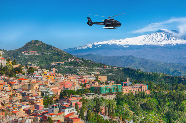 Scenic Eclipse helicopter flying over a European town