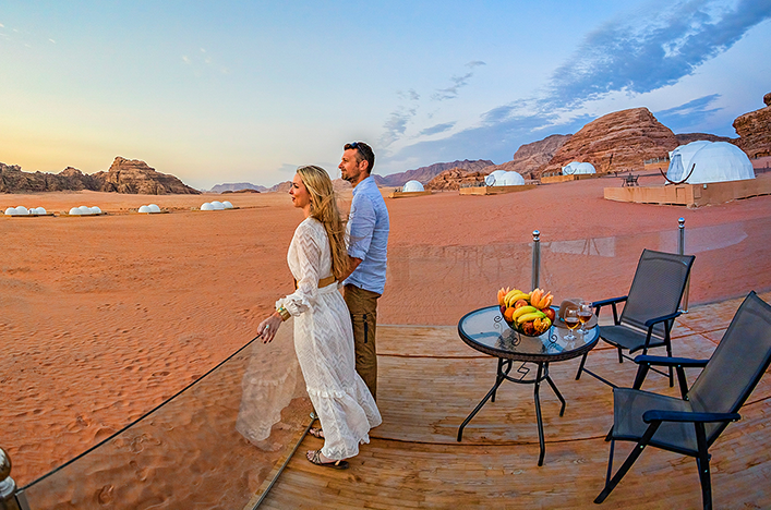 A couple looking out over the Wadi Rum desert at UFO Luxotel