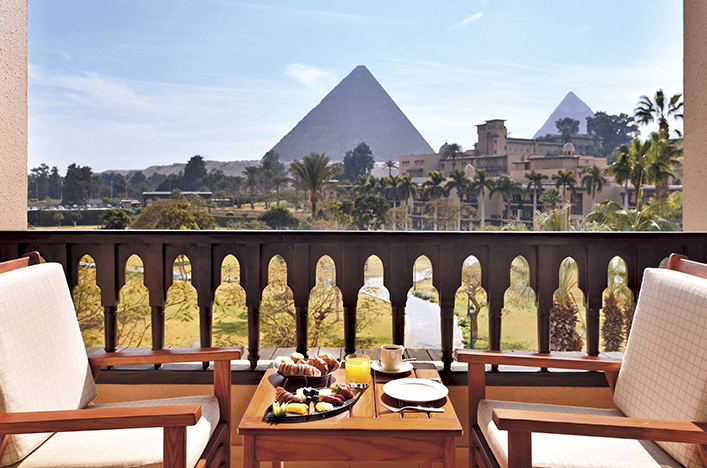 Chairs and table with breakfast overlooking the ancient pyramids 