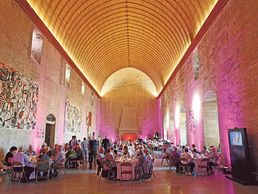 People sitting inside the Palais des Papes, Avignon, France