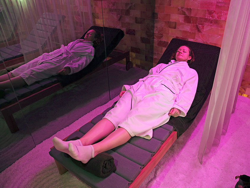 A woman relaxing on a lounger in the Salt Therapy Lounge on theScenic Diamond ship 