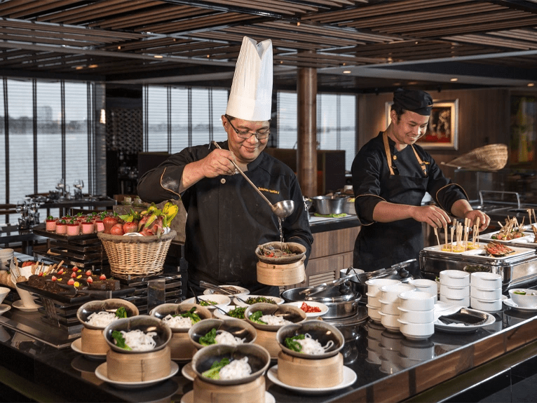 Chefs preparing food in Crystal Dining on board the Scenic Spirit ship