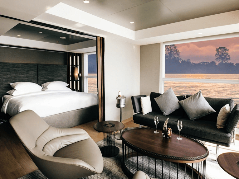 Separate lounge area and Queen bed in the Royal Panorama Suite on the Scenic Spirit cruise ship