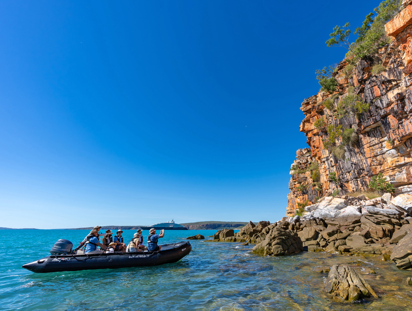 Tour group in Zodiac viewing wildlife on coastline