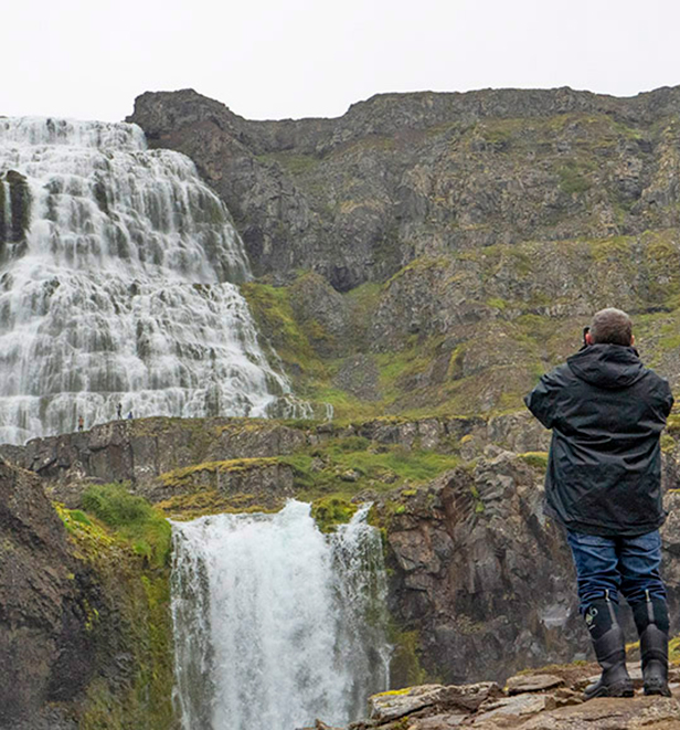 Scenic Eclipse guests exploring a waterfall in Dynjandivogur, Iceland