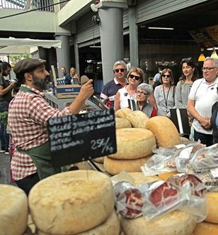 Guests shopping with a chef and trying local produce