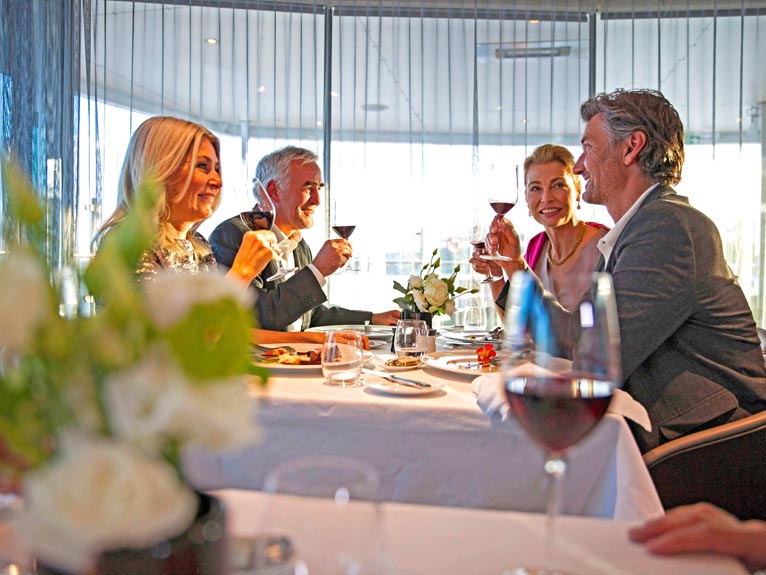 Guests enjoying dinner on board Scenic space ship