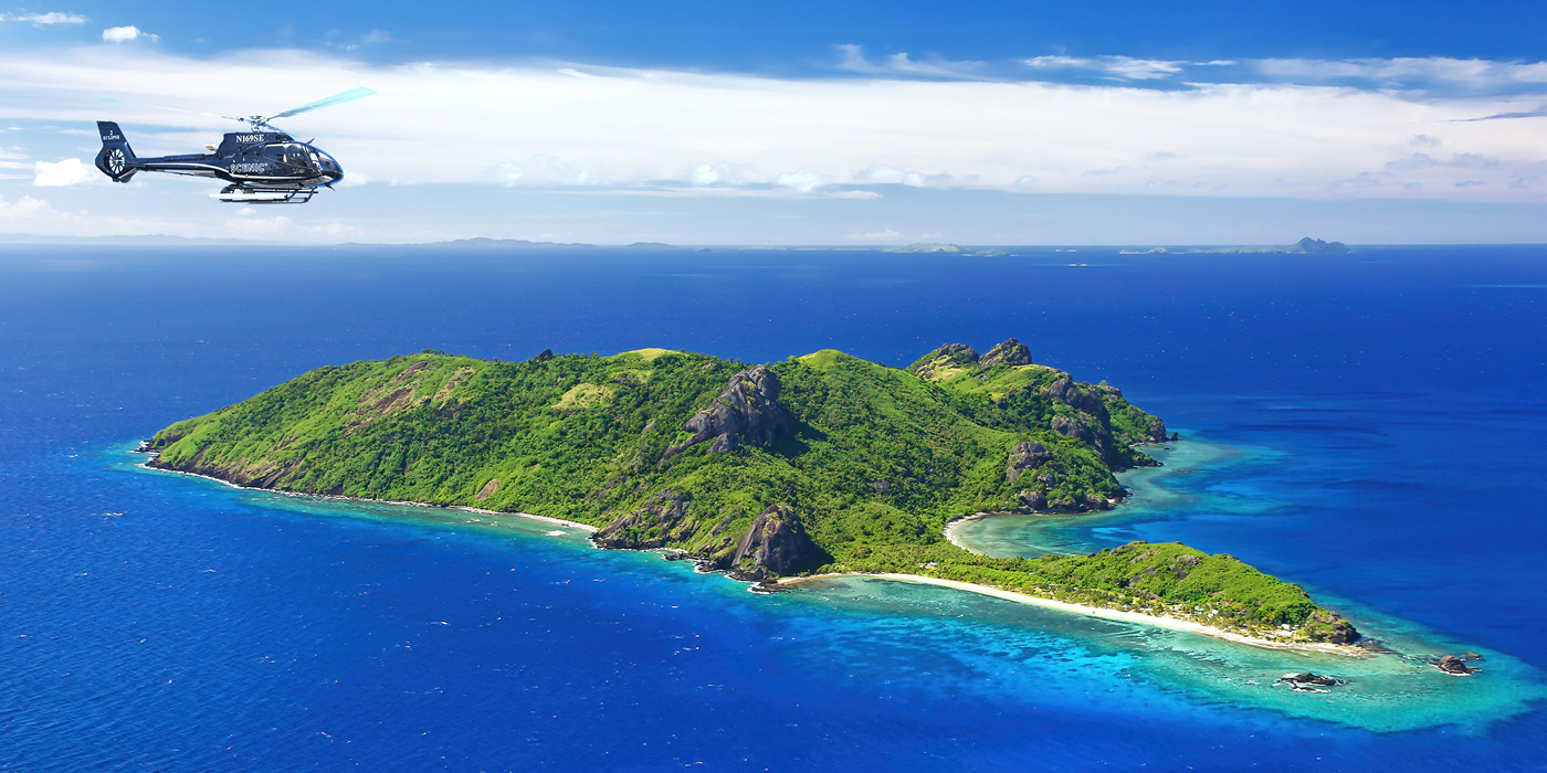 Scenic helicopter flying over an island in Fiji