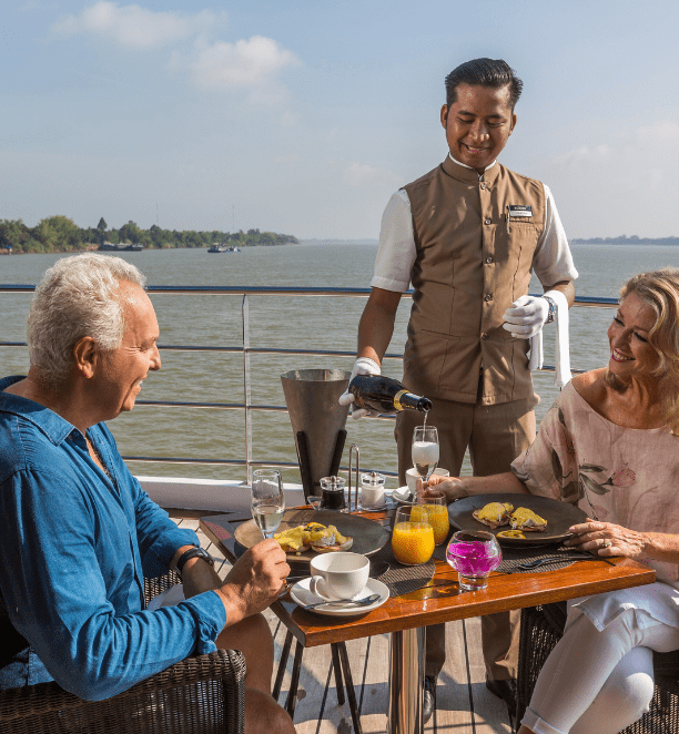 Butler pouring champagne for guests