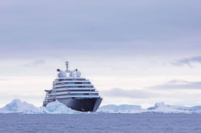 Scenic Eclipse in Antarctica Scenic Eclipse sailing through icy waters surrounded by icebergs in Antarctica