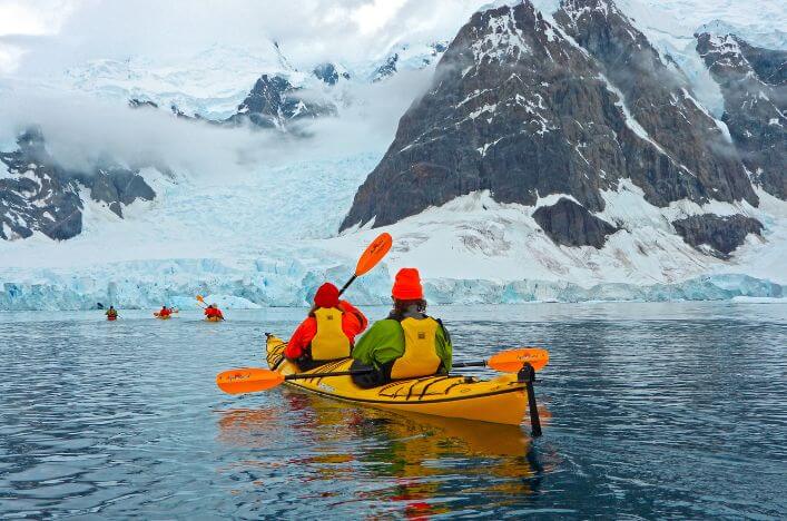 Kayaking Excursion in Antarctica with Scenic Eclipse Guests kayaking through icy waters during a Scenic Eclipse excursion in Antarctica