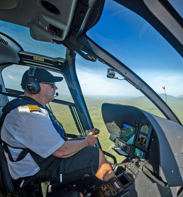Helicopter pilot flying over Cape York