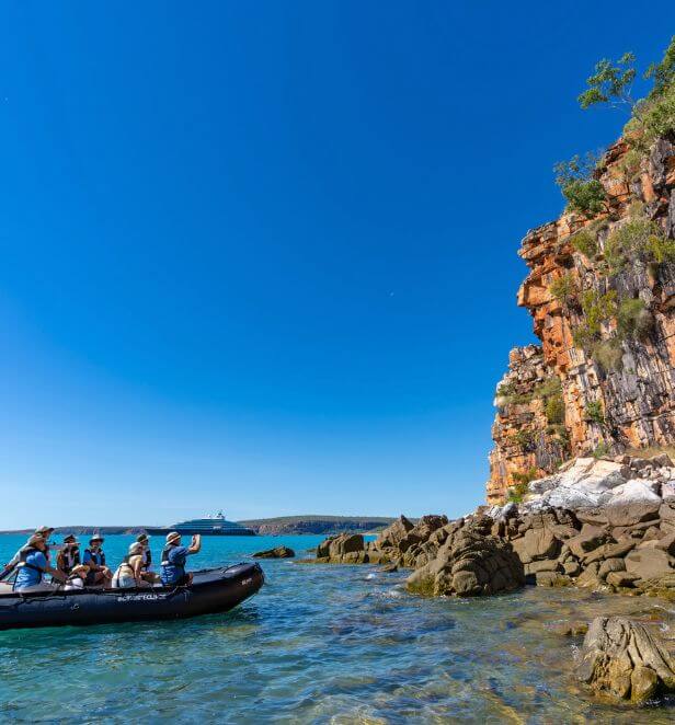 Zodiac tour near red cliffs in Australia