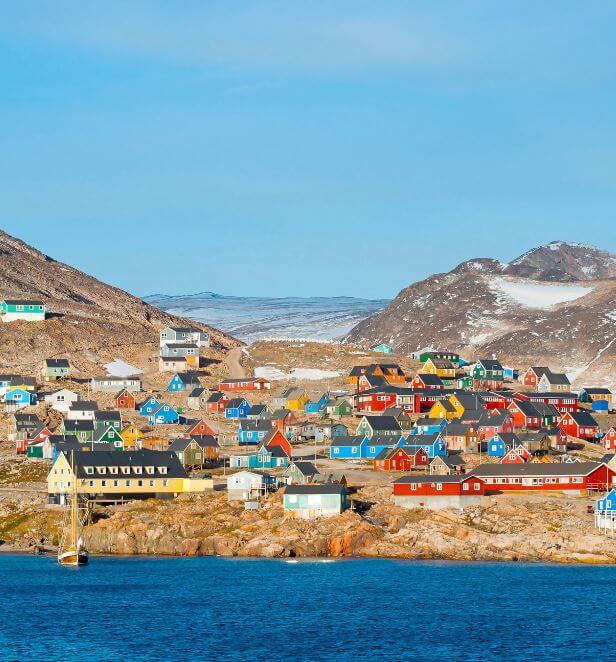 Colorful houses dotting the rocky coastline of Ittoqqortoormiit, Greenland