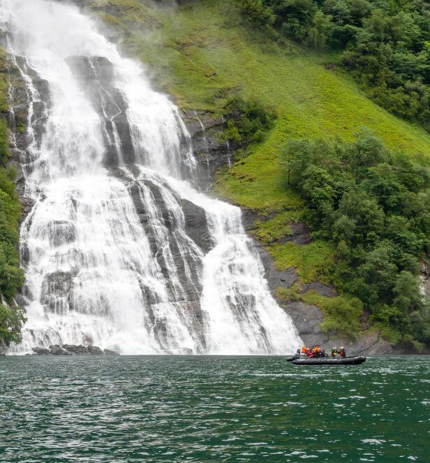 Guests on a small Zodiac boat cruise in Geiranger, Norway