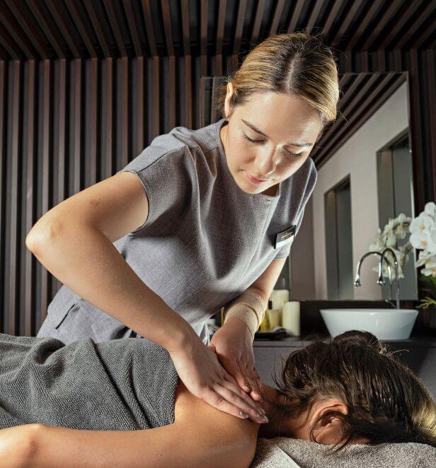 Spa therapist giving a back massage at Senses Spa, Scenic Eclipse