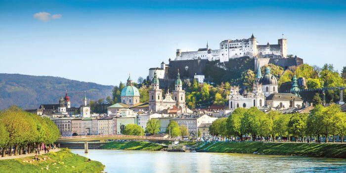 River view of Salzburg with historic buildings and fortress in Austria