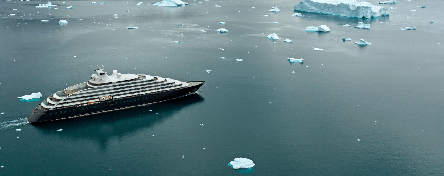 Scenic Eclipse sailing among icebergs in the coastal waters of Greenland