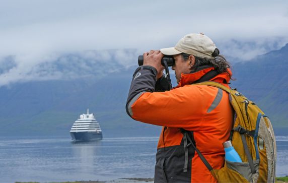 Guest observing from shore with Scenic Eclipse in the distance