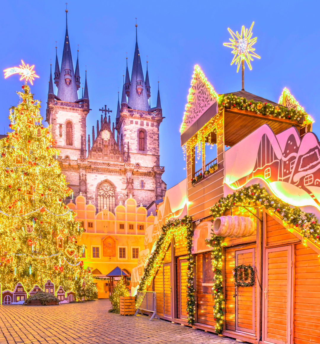 Brightly lit Christmas market scene at dusk